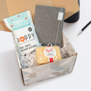 Custom Corporate Gift Sets: Hello There Light Set with Poppy Popcorn, Byrd's Cookie Rice Crispies, and a Libretto Journal. Order in bulk from Brand Spirit.