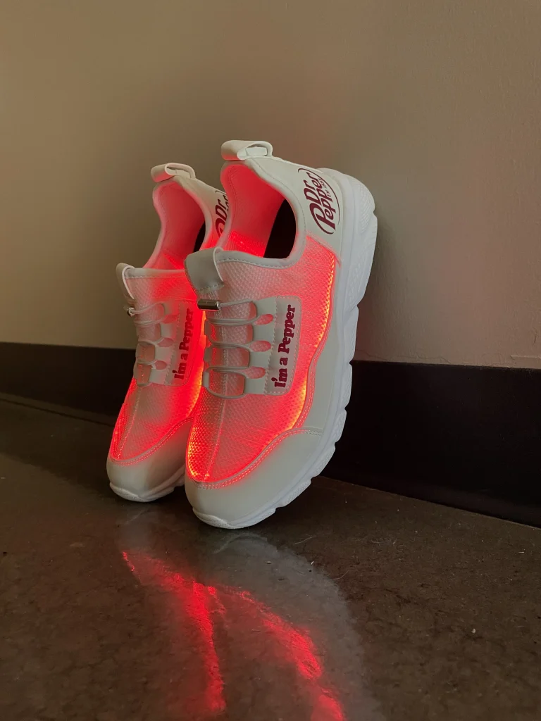 Custom promotional light up sneakers with the option to fully personalize. Light colors can vary from blue, white and red.