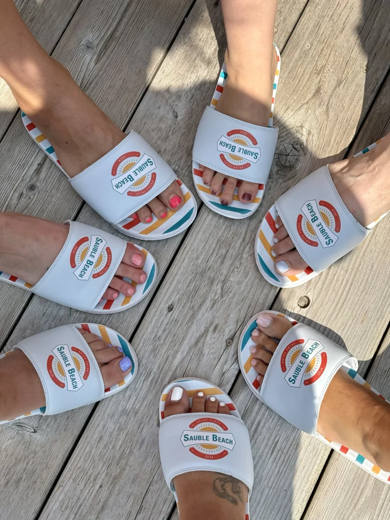 Custom promotional slides with printed soles. White base color but offered with full-color wrap decoration.